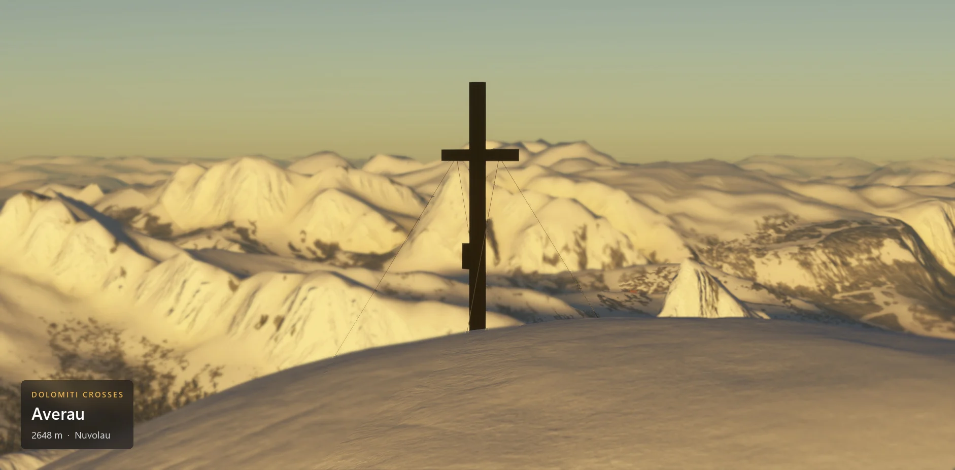 The summit cross on Averau (2648 m) seen from the side, with winter snow, with the caption plate in the lower left corner.