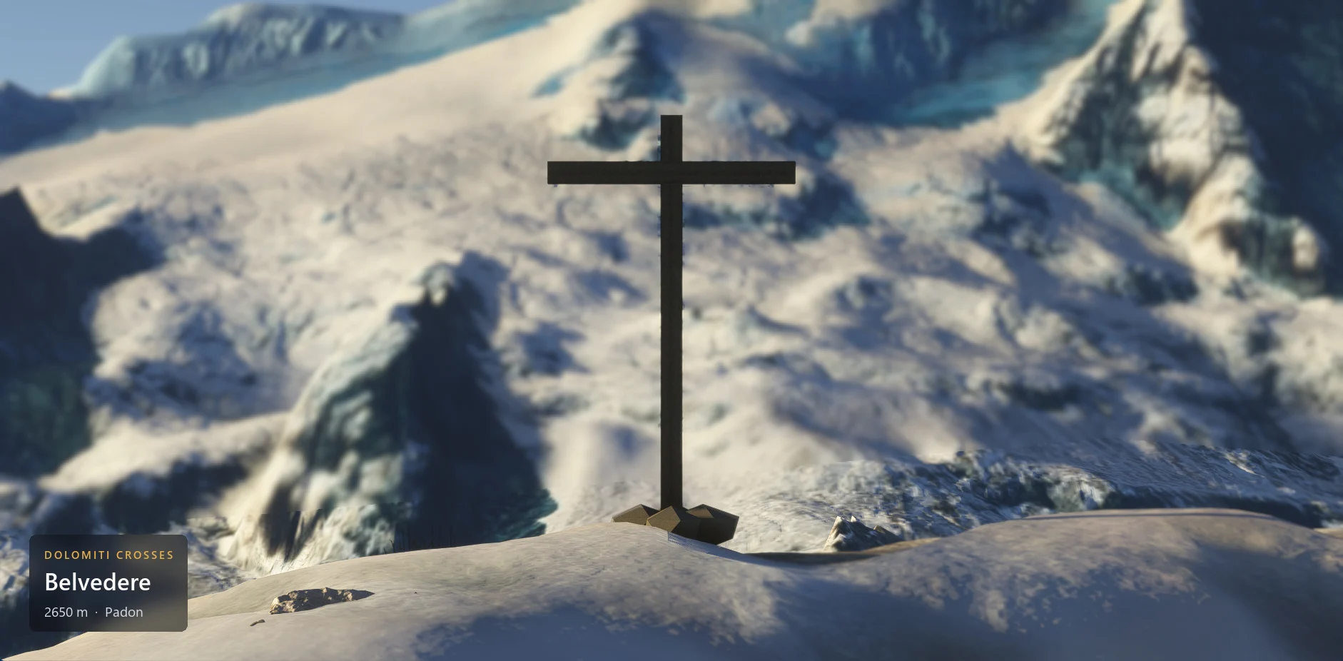 The summit cross on Belvedere (2650 m) seen from the front, with the caption plate in the lower left corner.