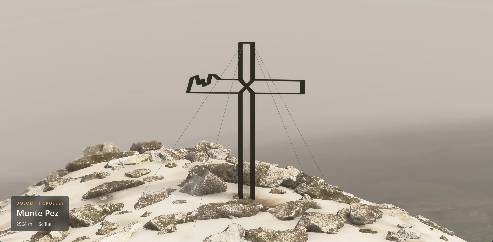 The summit cross on Monte Pez (2568 m) seen from the front, in hazy overcast weather, with the caption plate in the lower left corner.