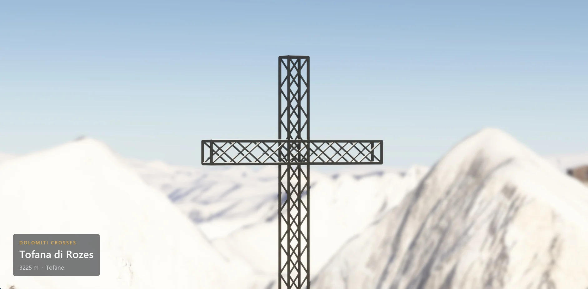 The summit cross on Tofana di Rozes (3225 m) in close-up, with winter snow, with the caption plate in the lower left corner.